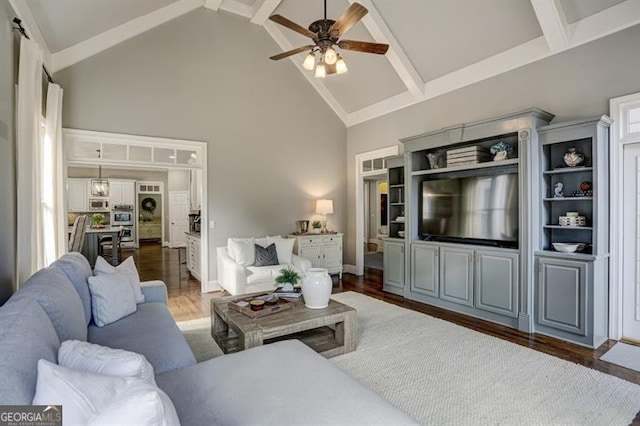 living area with a ceiling fan, beamed ceiling, high vaulted ceiling, and wood finished floors