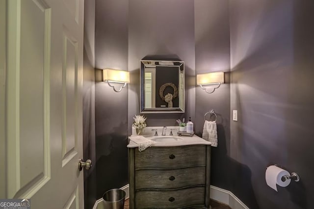 bathroom with vanity and baseboards