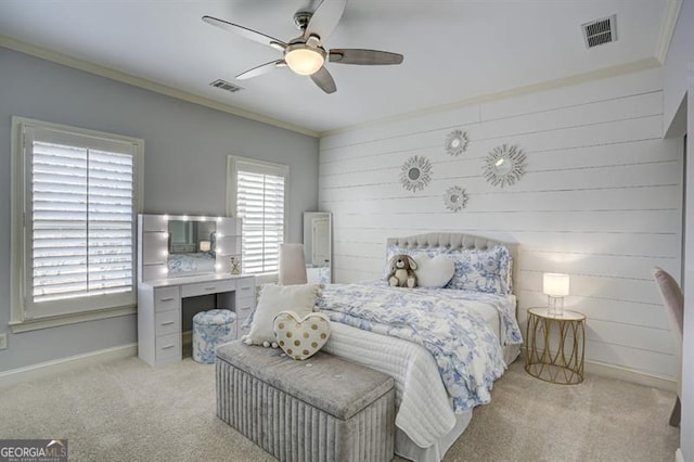 bedroom featuring crown molding, baseboards, visible vents, and light colored carpet