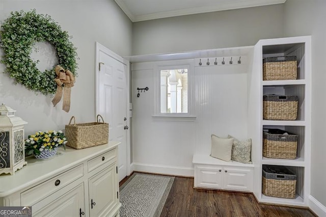 mudroom featuring dark wood-type flooring, ornamental molding, and baseboards