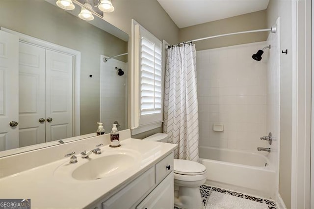 bathroom featuring toilet, tile patterned floors, shower / bath combo with shower curtain, and vanity