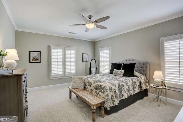 carpeted bedroom featuring ornamental molding, multiple windows, visible vents, and baseboards