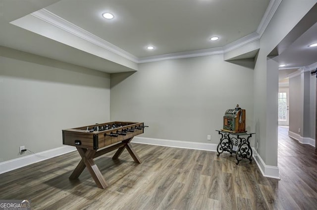 game room with ornamental molding, recessed lighting, baseboards, and wood finished floors