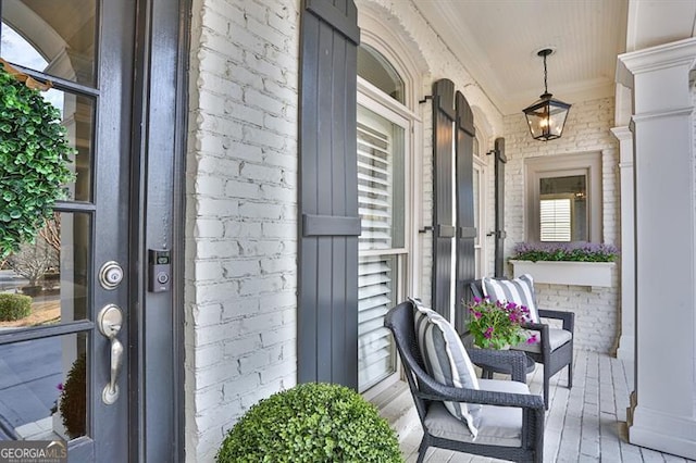 exterior space featuring covered porch and brick siding