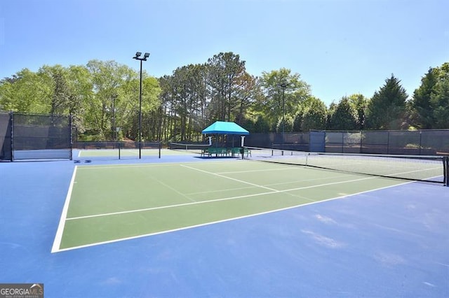 view of sport court with fence