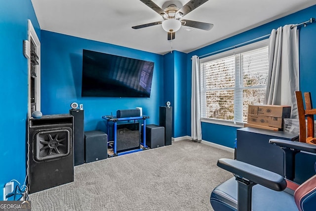 interior space with carpet, a ceiling fan, and baseboards