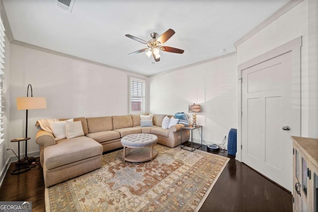 living area featuring crown molding, visible vents, a ceiling fan, wood finished floors, and baseboards