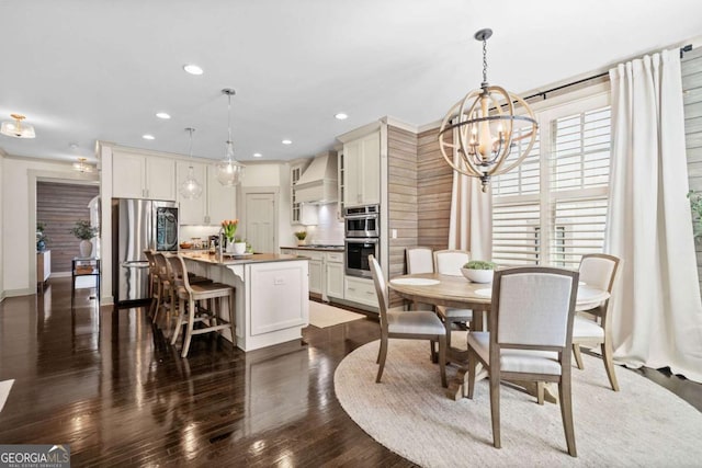 dining area featuring dark wood-style floors, recessed lighting, and an inviting chandelier