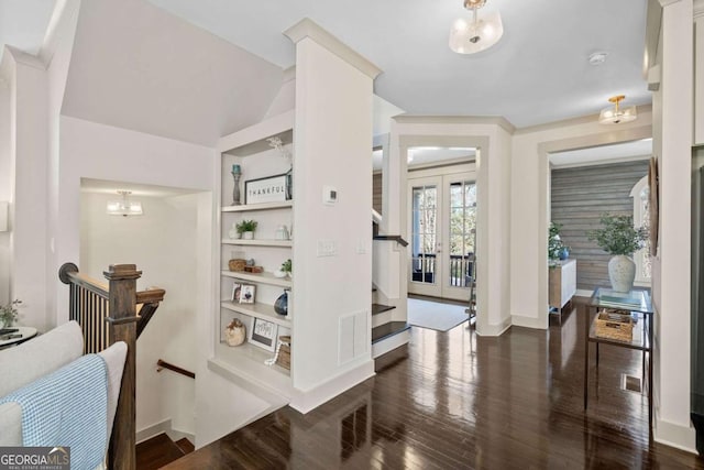 interior space featuring baseboards, visible vents, dark wood finished floors, and french doors