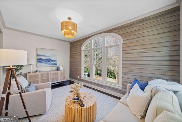 living area with wooden walls, visible vents, and wood finished floors