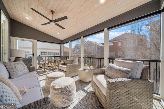 sunroom / solarium with vaulted ceiling, wood ceiling, and a ceiling fan