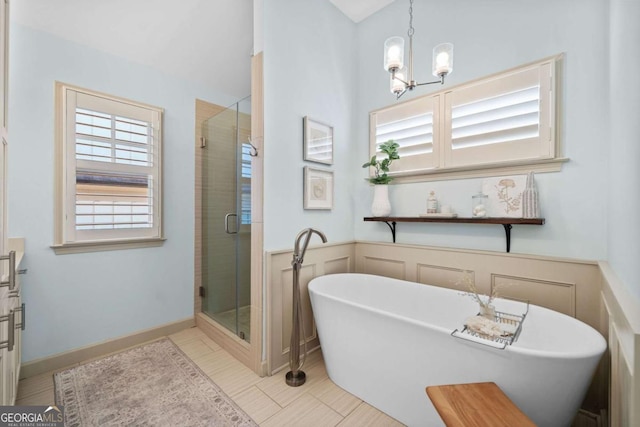 203 Hubbard Rd, Woodstock, GA 30188 - full bathroom featuring a freestanding tub, a shower stall, tile patterned floors, and a chandelier
