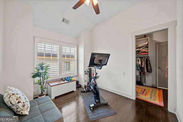 exercise room with lofted ceiling, visible vents, ceiling fan, wood finished floors, and baseboards