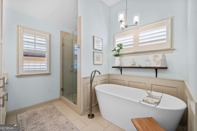 full bath featuring a stall shower and a freestanding tub