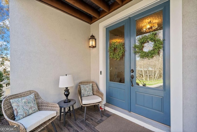 property entrance featuring french doors and stucco siding