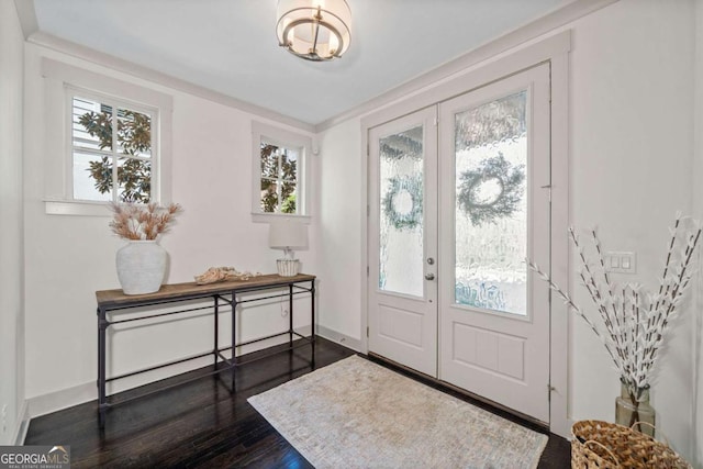 foyer entrance featuring dark wood-style floors, french doors, and baseboards