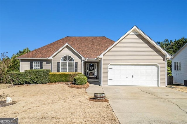 ranch-style home featuring driveway and a garage