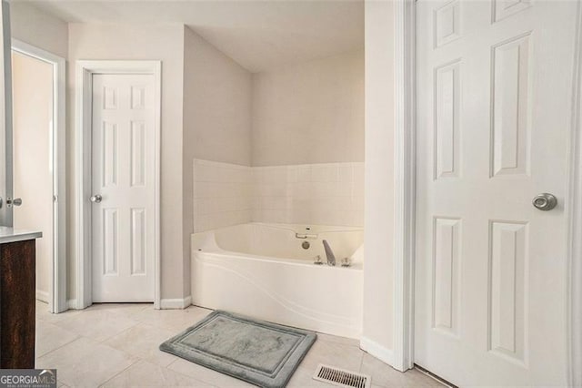 full bath featuring visible vents, a garden tub, vanity, and tile patterned floors