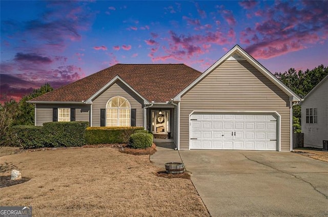 ranch-style home featuring an attached garage and concrete driveway