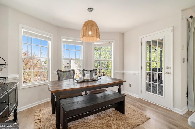 dining space with light wood-style floors and baseboards