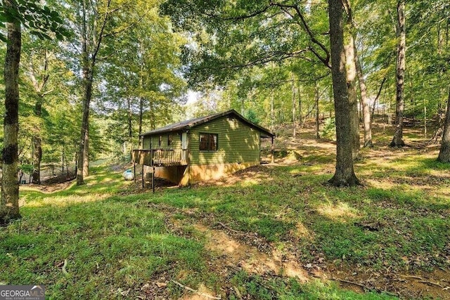 view of property exterior featuring a wooded view