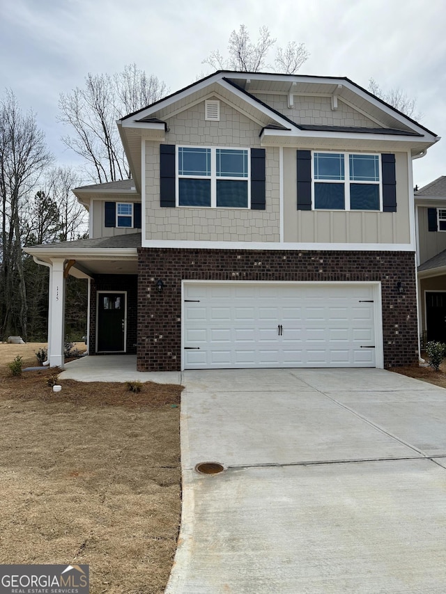 view of front of house featuring a garage, driveway, brick siding, and board and batten siding