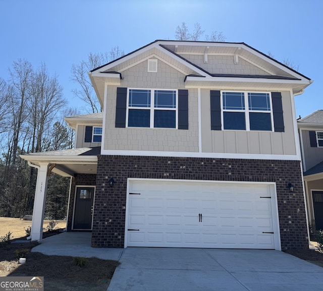 view of front of property with driveway, brick siding, and an attached garage