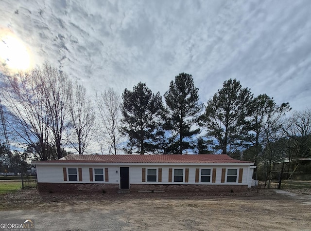 ranch-style home with metal roof