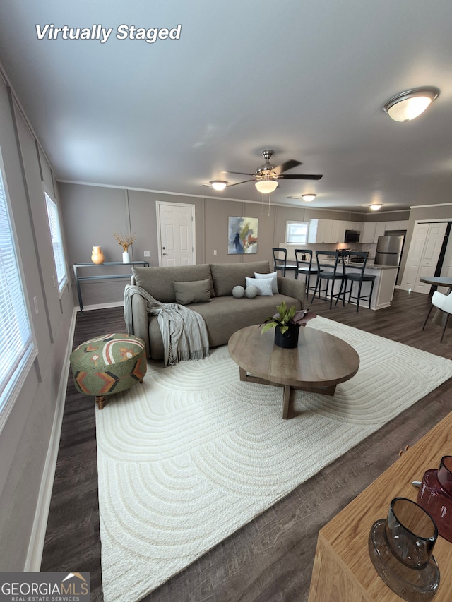 kitchen featuring white cabinets, a sink, light stone countertops, dark wood-type flooring, and stainless steel appliances