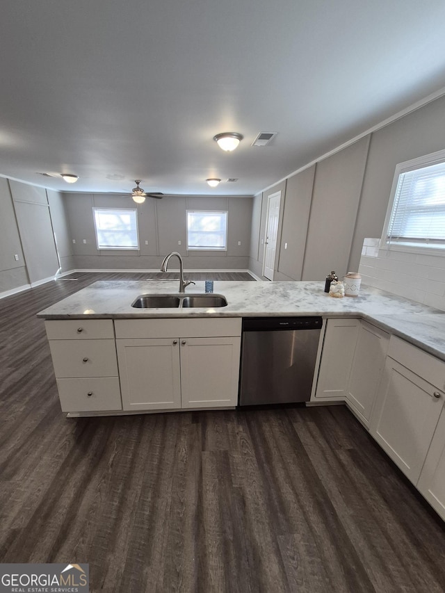 kitchen featuring light stone countertops, white cabinetry, visible vents, dishwasher, and a sink