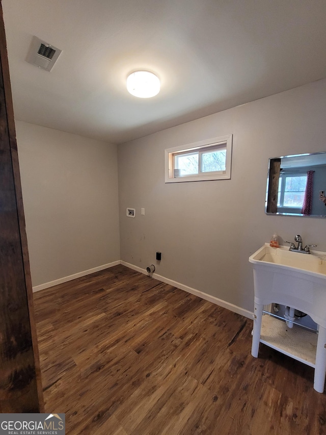 laundry room featuring laundry area, washer hookup, wood finished floors, visible vents, and baseboards