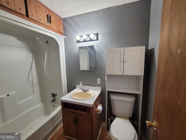 bathroom with shower / washtub combination, toilet, a textured ceiling, and vanity