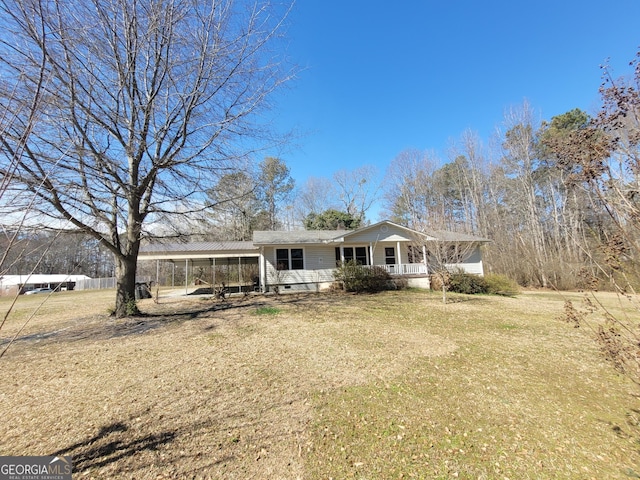 single story home featuring a porch, a front yard, crawl space, and a detached carport