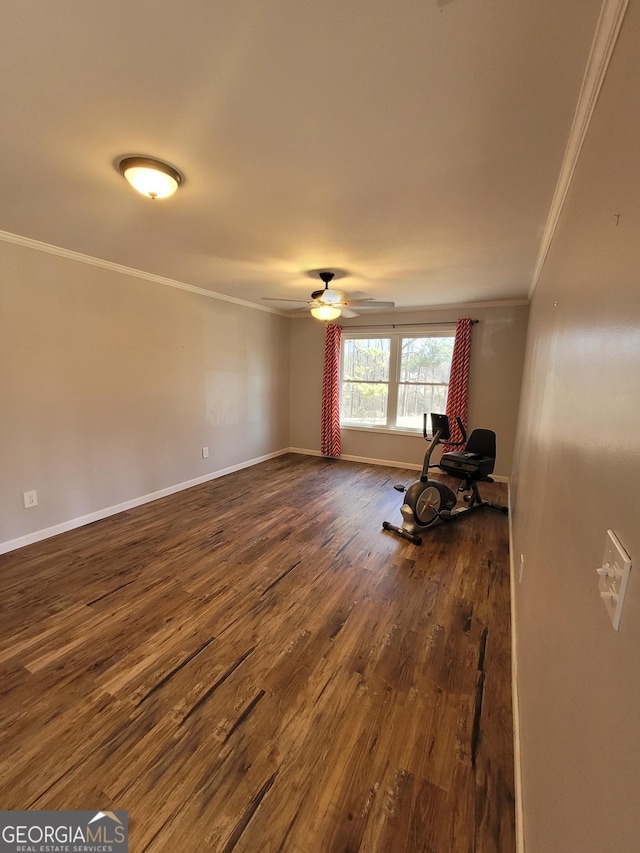 interior space with ceiling fan, ornamental molding, dark wood-style flooring, and baseboards