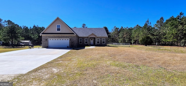 view of front of property with concrete driveway, brick siding, and a front lawn