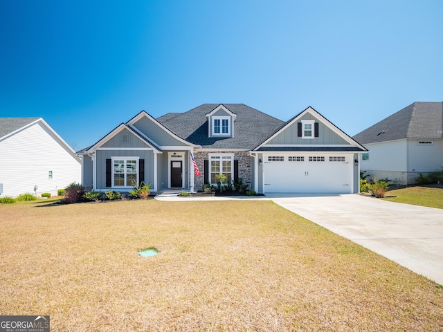 view of front of home featuring concrete driveway, board and batten siding, and a front yard