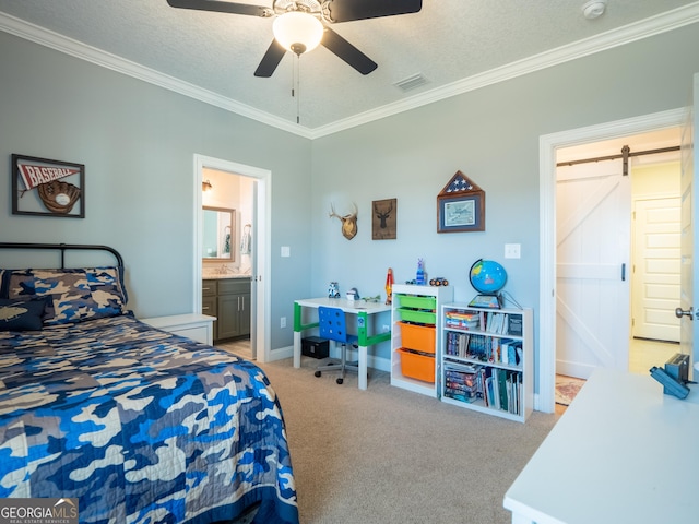 bedroom with ornamental molding, a barn door, a textured ceiling, and carpet