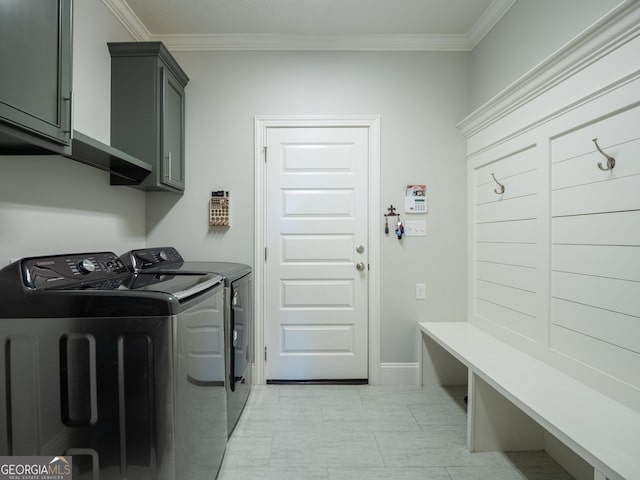 clothes washing area featuring cabinet space, baseboards, crown molding, and independent washer and dryer