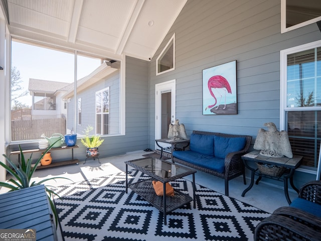 sunroom / solarium with lofted ceiling with beams