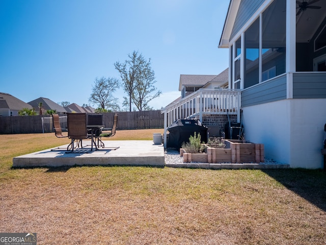 view of yard with a vegetable garden, a patio area, and fence