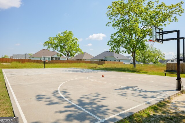 view of basketball court with community basketball court and fence