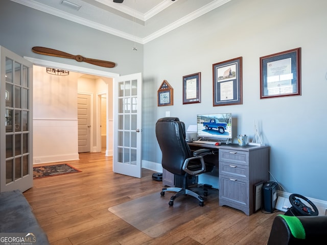 office space with french doors, visible vents, ornamental molding, baseboards, and hardwood / wood-style flooring