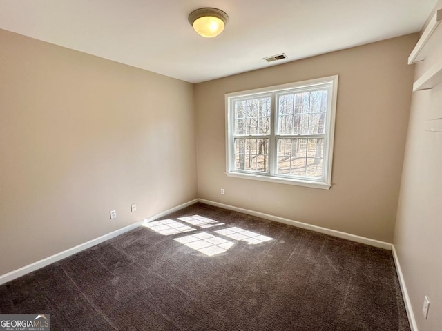 carpeted empty room with visible vents and baseboards