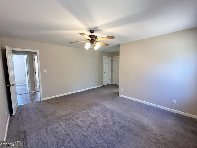 empty room featuring carpet flooring, a ceiling fan, and baseboards