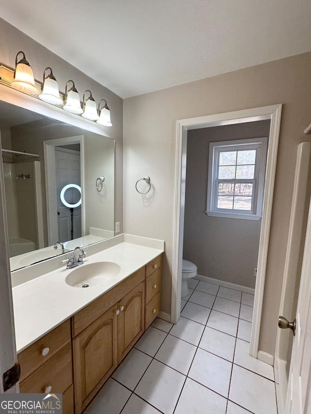 full bathroom featuring baseboards, a shower, toilet, tile patterned flooring, and vanity