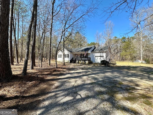 view of home's exterior featuring gravel driveway and a garage