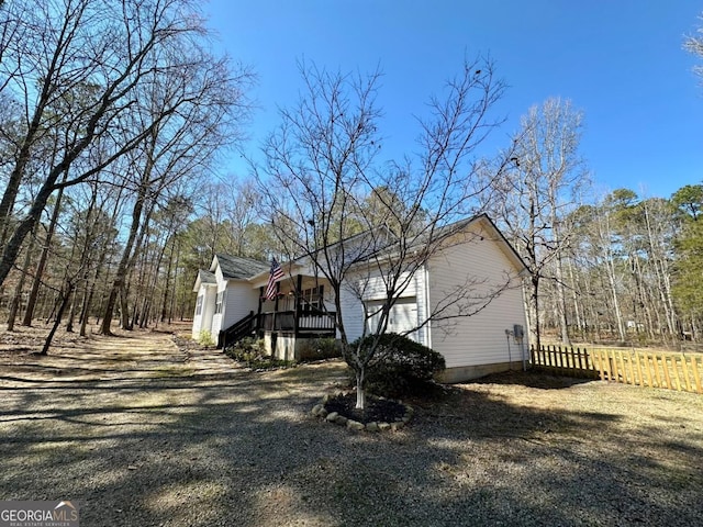 view of side of home with fence