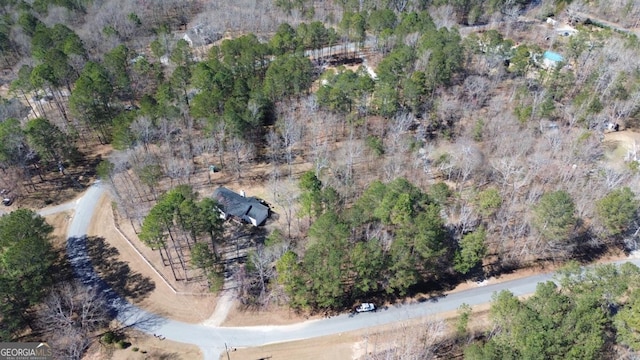 birds eye view of property featuring a wooded view