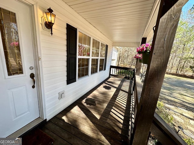 wooden terrace featuring covered porch