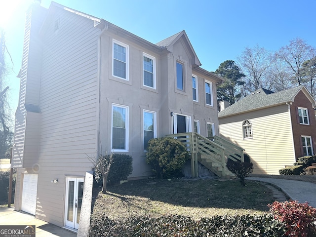 view of property exterior with a garage and driveway